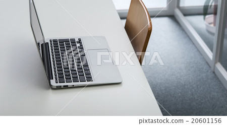 A bright office workspace with a laptop computer. A bright office workspace with a laptop computer. 20601156