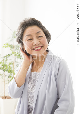 Beauty Image Senior woman arranging hair style while watching mirror Beauty Image Senior woman arranging hair style while watching mirror 20601338