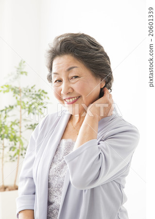 Beauty Image Senior woman arranging hair style while watching mirror Beauty Image Senior woman arranging hair style while watching mirror 20601339