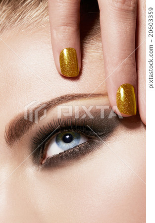 Foreigner model. Beauty. Cosmetic image. Golden nails 20603359