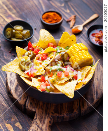 Nachos with melted cheese sauce, salsa, corn cobs 20605037