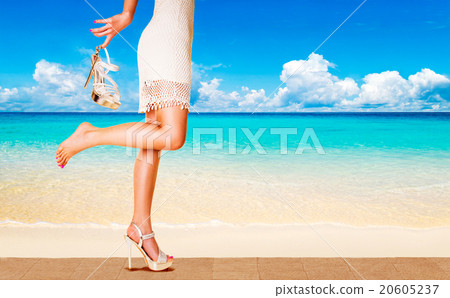 A woman running on the beach with a beautiful mule 20605237