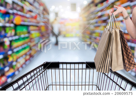 Holding shoping bags by hand on Supermarket with Abstract blurre 20609575