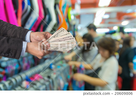 Businessman offered the money on the Abstract blurred photo of s Businessman offered the money on the Abstract blurred photo of s 20609806
