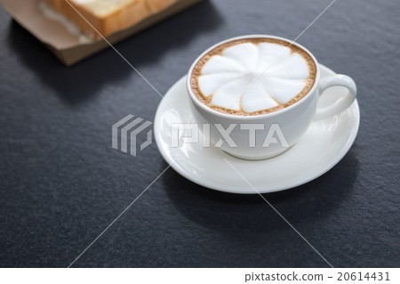 Hot art latte coffee in cup on black table Hot art latte coffee in cup on black table 20614431