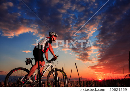 Man Cyclist with bike on sunset Man Cyclist with bike on sunset 20621269