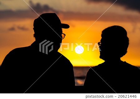 Senior couple looking at the setting sun Senior couple looking at the setting sun 20621446