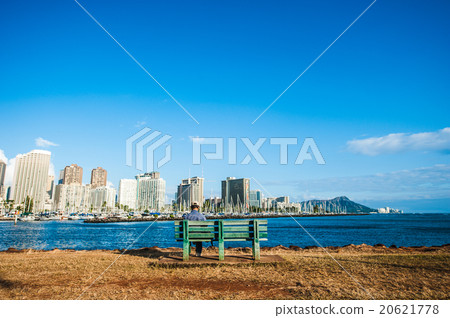 Middle-aged man sit lonesome on the coastal bench Middle-aged man sit lonesome on the coastal bench 20621778
