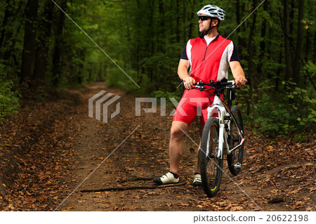 Bicyclist with His Bicycle in the Summer Forest 20622198