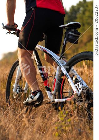 Cyclist with His Bike on the Autumn Meadow 20622237