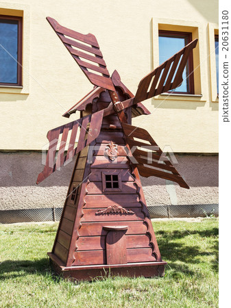 Decorative wooden windmill in the garden, carving art Decorative wooden windmill in the garden, carving art 20631180