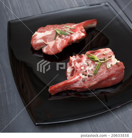 fresh lamb on a black plate fresh lamb on a black plate 20633838