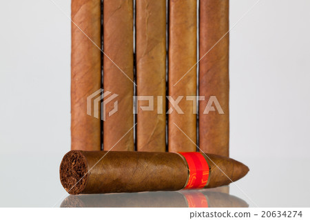 Different cigars on a  glass desk 20634274