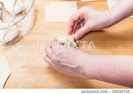 woman prepares dumplings from rolled dough woman prepares dumplings from rolled dough 20636740