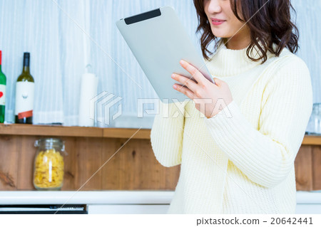 Woman's hand at hand operating tablet PC in kitchen White kitchen Kitchen Cookery Recipe search Menu Search 20642441