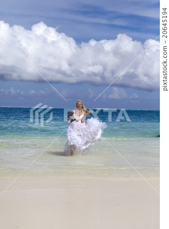 woman in a wedding dress runs on waves of the sea woman in a wedding dress runs on waves of the sea 20645194