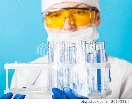Woman chemist examines test tube Woman chemist examines test tube 20645214