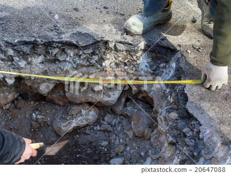 workers check a tape measure 20647088