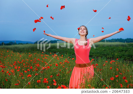 Happy girl in a red dress on poppy field - Stock Photo [20647383] - PIXTA