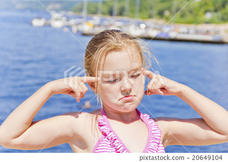 Cute girl on the riverbank in pink swimsuit 20649104