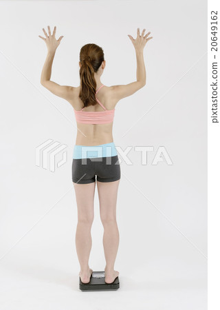 A young woman who rejoices taking a scale 20649162
