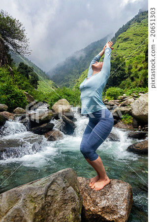 Sorty fit woman doing yoga asana at waterfall Sorty fit woman doing yoga asana at waterfall 20651303