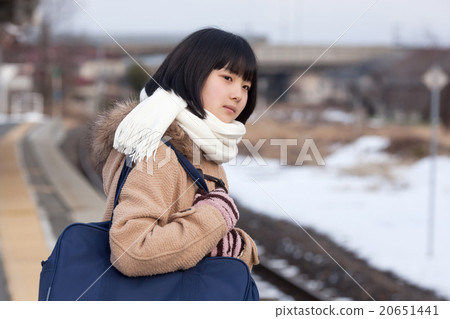 Girls junior high school students going to school by train 20651441