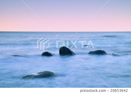 Romantic at sea. Boulders sticking out from water 20653642