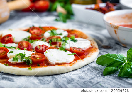 Prepering margherita pizza with mozzarella Prepering margherita pizza with mozzarella 20659778