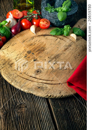 board with vegetables, herbs and a stone grinder board with vegetables, herbs and a stone grinder 20659780