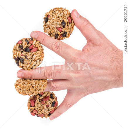 Candied roasted peanuts seeds in hand. Candied roasted peanuts seeds in hand. 20661734