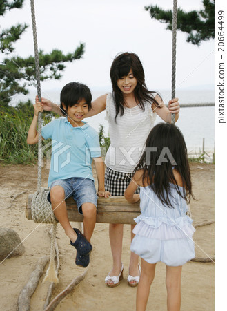 Parent-child playing with hand-made swings 20664499