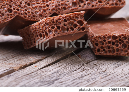 pile of porous chocolate on old wooden table 20665269