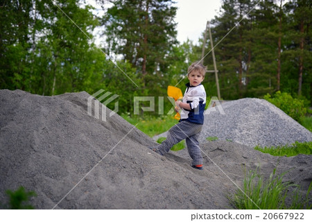 Little boy plays on heap of crushed stone 20667922
