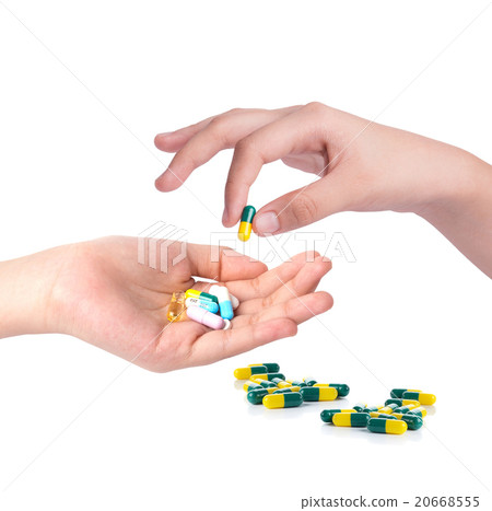 Drug capsules and pills in hand 20668555