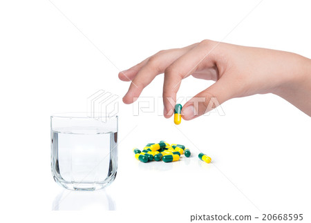 Drug capsule in hand with drinking water Drug capsule in hand with drinking water 20668595