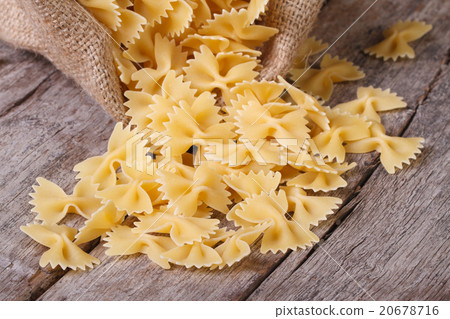 Farfalle pasta dry closeup is scattered Farfalle pasta dry closeup is scattered 20678716