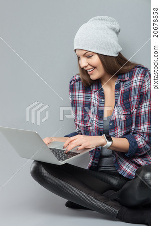 Attractive girl is using a notebook for fun Attractive girl is using a notebook for fun 20678858