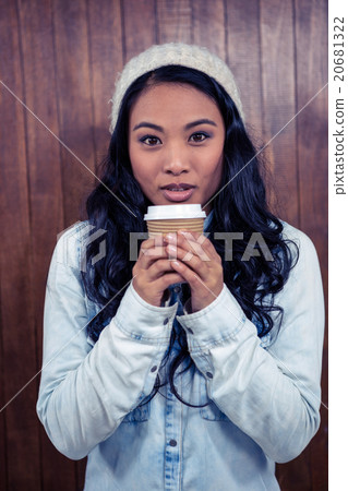 Asian woman holding disposable cup 20681322