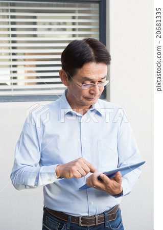 Serious man using tablet 20681335