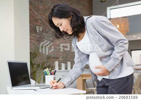 Pregnant woman reading documents 20681589