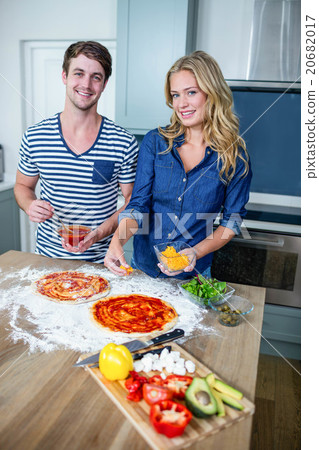 Smiling couple preparing pizza Smiling couple preparing pizza 20682017
