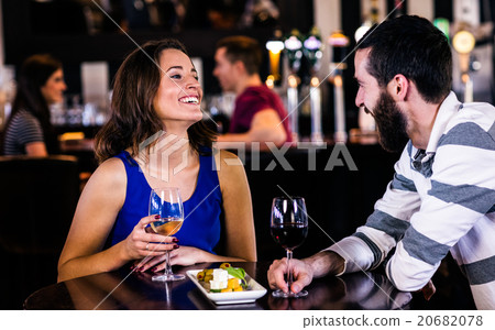 Couple having a glass of wine Couple having a glass of wine 20682078