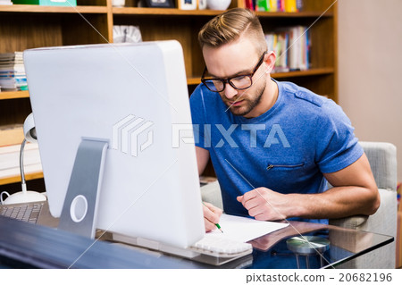 Serious designer drawing at desk Serious designer drawing at desk 20682196