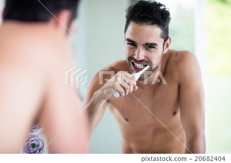 Portrait of a handsome man brushing teeth Portrait of a handsome man brushing teeth 20682404