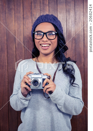 Asian woman holding digital camera Asian woman holding digital camera 20682414