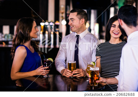 Friends talking and having a drink Friends talking and having a drink 20682688