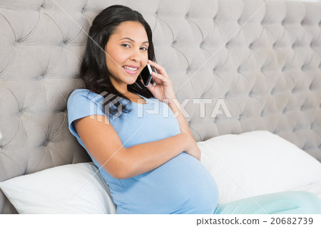 Pregnant brunette on phone call 20682739
