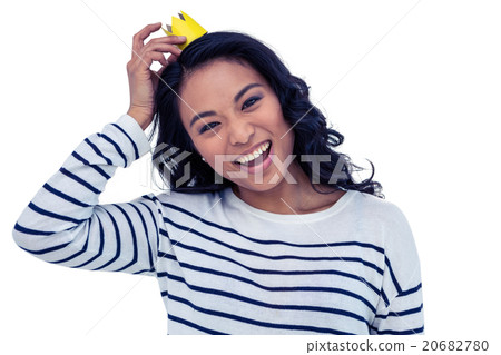 Smiling Asian woman with paper crown Smiling Asian woman with paper crown 20682780