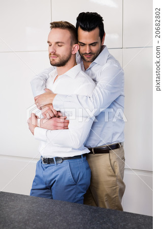 Gay couple with eyes closed hugging Gay couple with eyes closed hugging 20682802